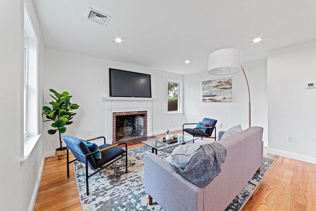 40 Howe Street Quincy, MA 02169 - Photo 10 of 42 a living room with furniture a flat screen tv and a fireplace