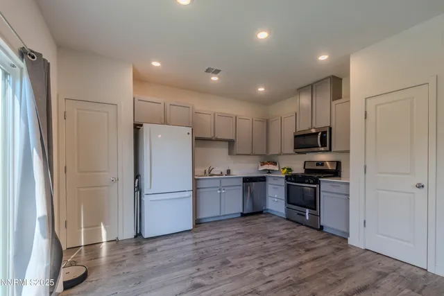 a kitchen with stainless steel appliances a stove a sink a stove a microwave and cabinets