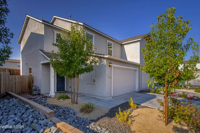 a house that has a tree in front of the house