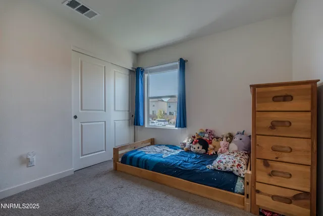 a view of a house with a yard and potted plants