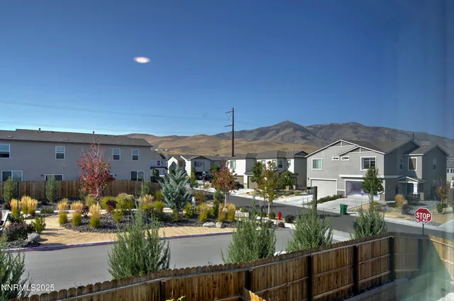 a view of a house with backyard and a patio