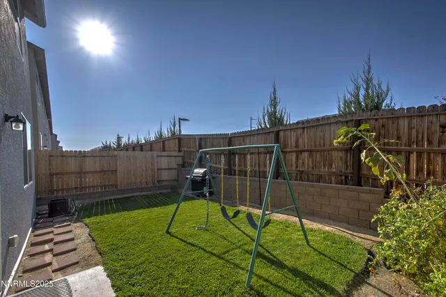a view of a backyard with sitting area