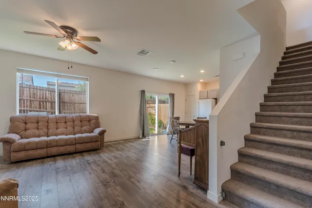 a living room with furniture and a ceiling fan