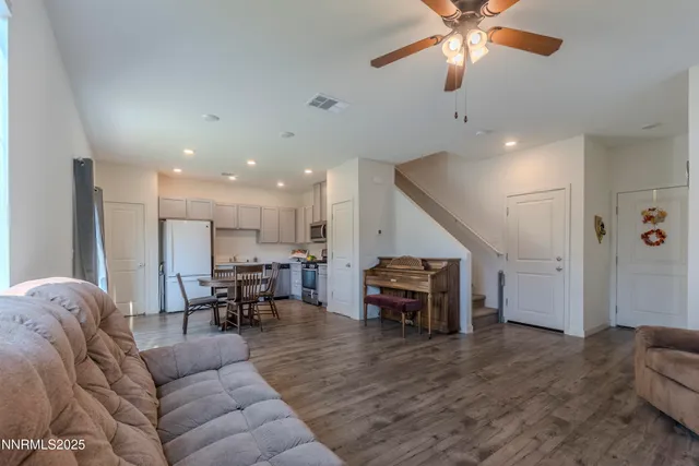 a living room with furniture and a air conditioner vent