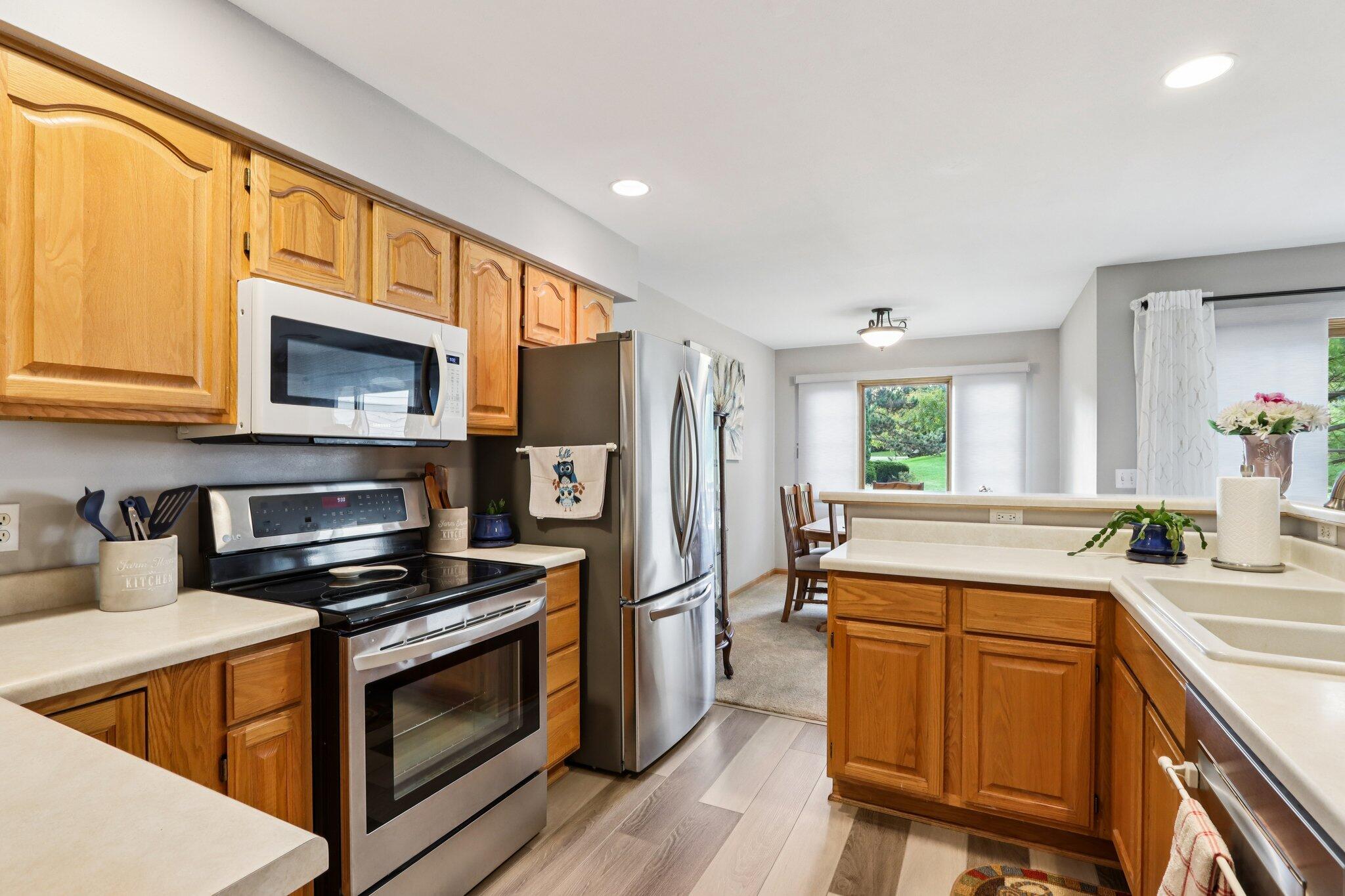 2264 Circle Ridge Road, Unit E Delafield, WI 53018 - Photo 13 of 35 Newer LVP flooring in Kitchen