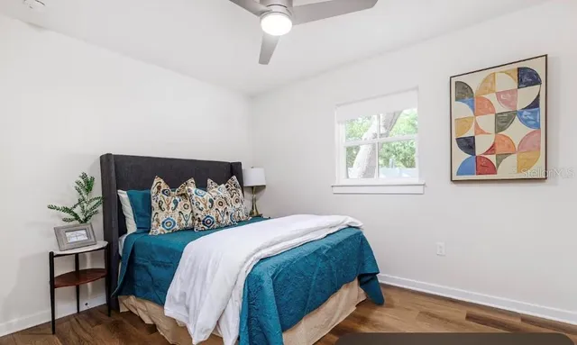 a bedroom with a bed and a window