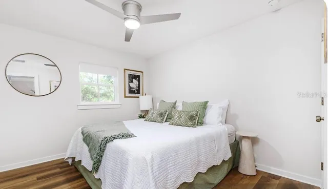 a bathroom with a granite countertop sink and a bathtub