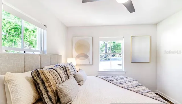 a bedroom with a bed and a window