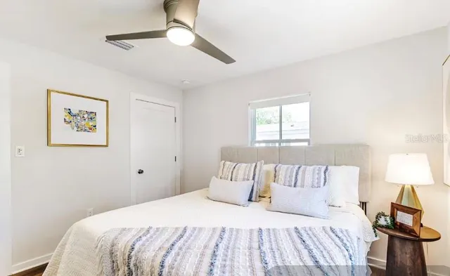 a bedroom with a bed and a window