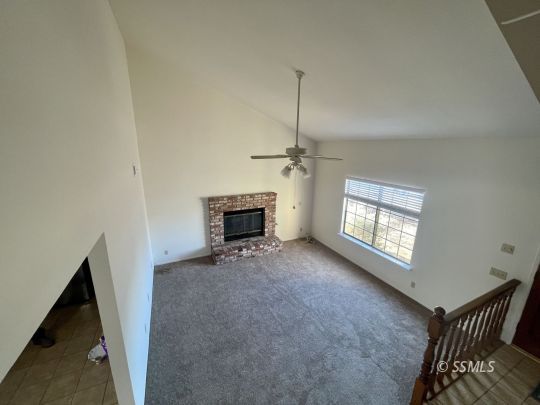 200 North American Street Ridgecrest, CA 93555 - Photo 16 of 23 a view of an empty room with a fireplace and a window