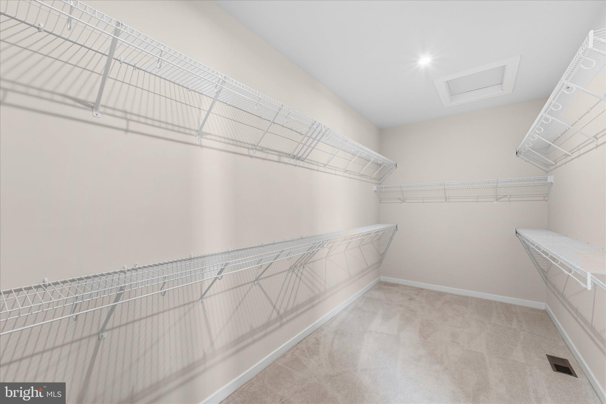 13695 Innovation Station Loop, Unit 77B Herndon, VA 20171 - Photo 17 of 36 Expansive Walk-In Closet with Built-In Storage