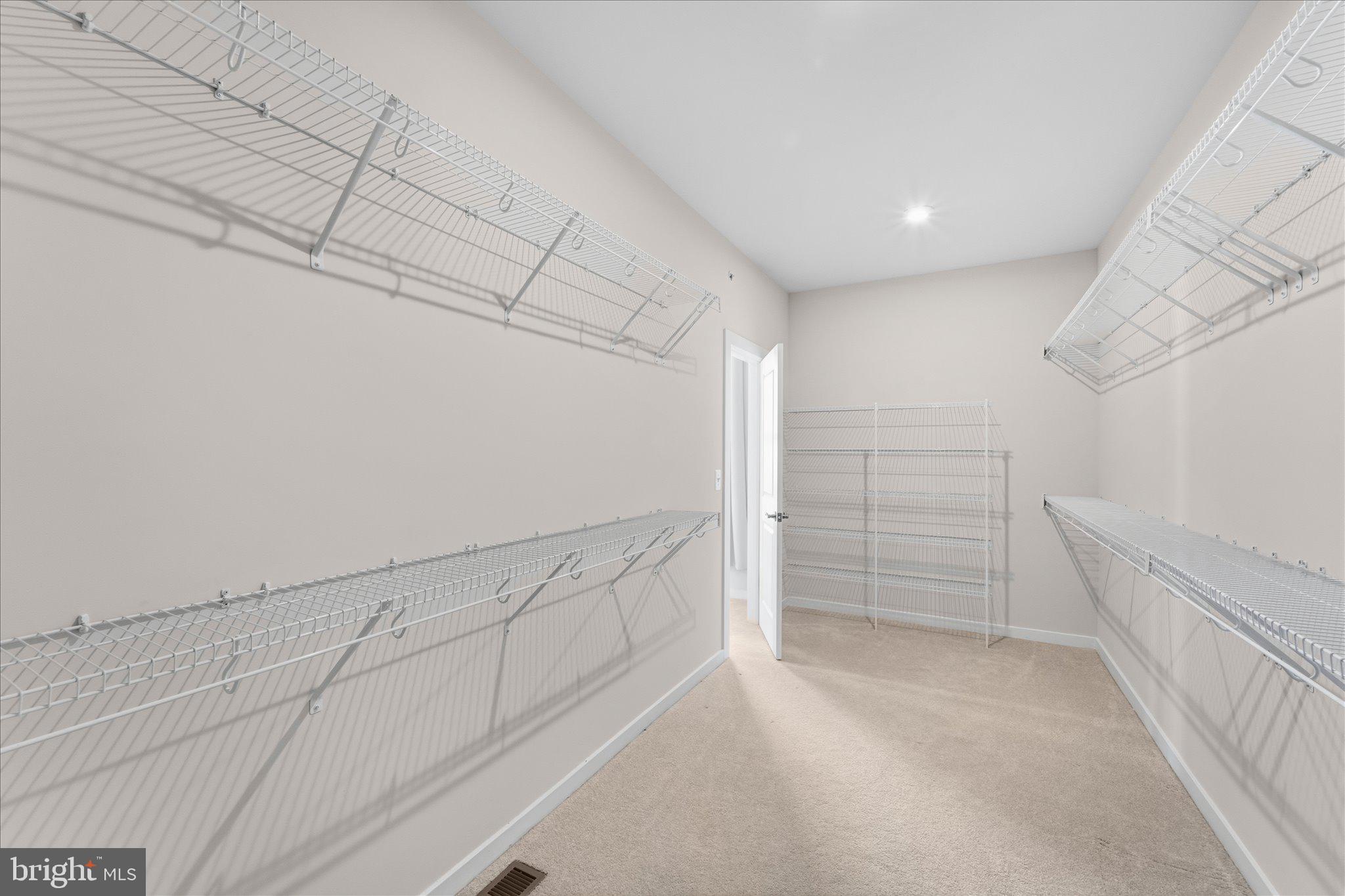 13695 Innovation Station Loop, Unit 77B Herndon, VA 20171 - Photo 18 of 36 Expansive Walk-In Closet with Built-In Storage