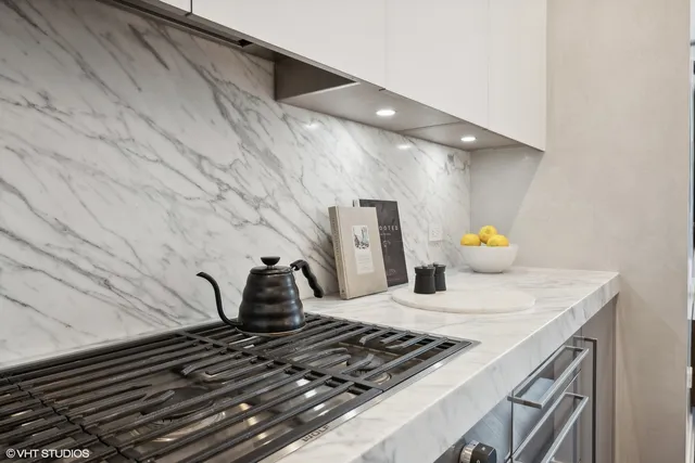 a kitchen with a stove and cabinets