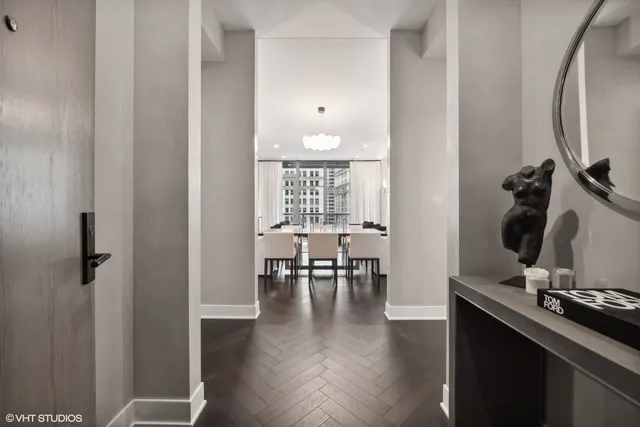 a view of a room with wooden floor and furniture