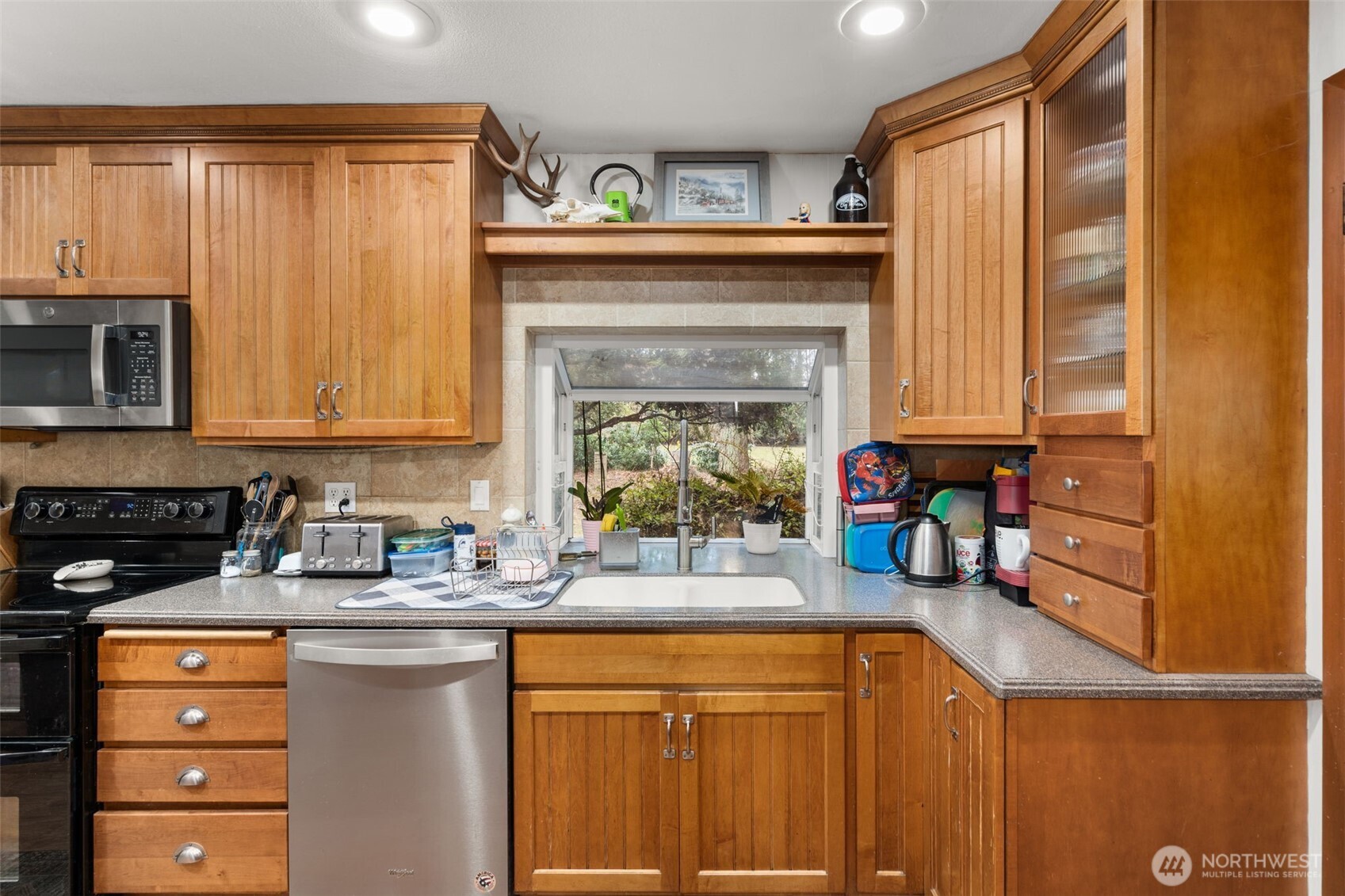 137 Aldrich Road Mossyrock, WA 98564 - Photo 13 of 30 a kitchen with stainless steel appliances a stove refrigerator sink and cabinets