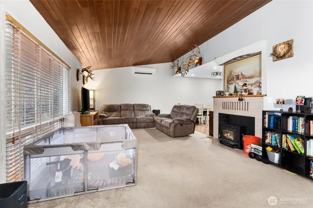 a living room with furniture a fireplace and a large window