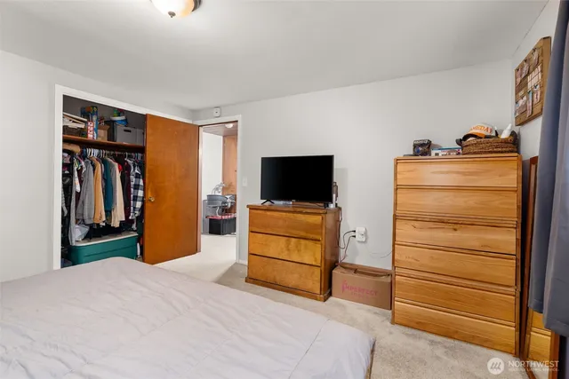 a bedroom with a bed and flat screen tv