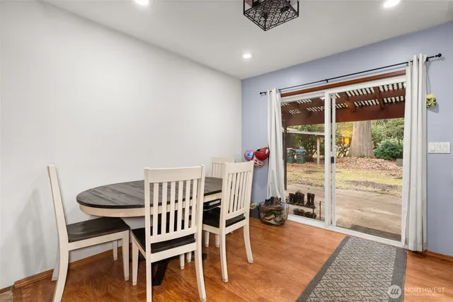 a view of a dining room with furniture and wooden floor