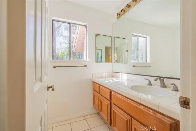 a bathroom with a granite countertop sink mirror and double