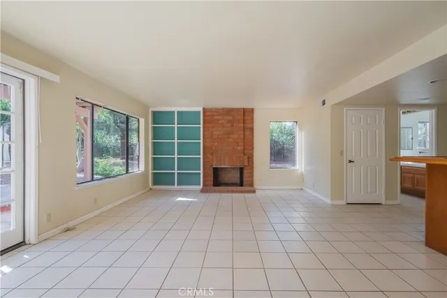 a view of a livingroom with an empty space and a window