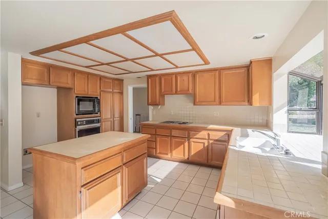 a kitchen with stainless steel appliances granite countertop a sink and cabinets