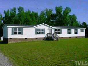 172 Foster Road Henderson, NC 27537 - Photo 1 of 1 a front view of a house with a garden