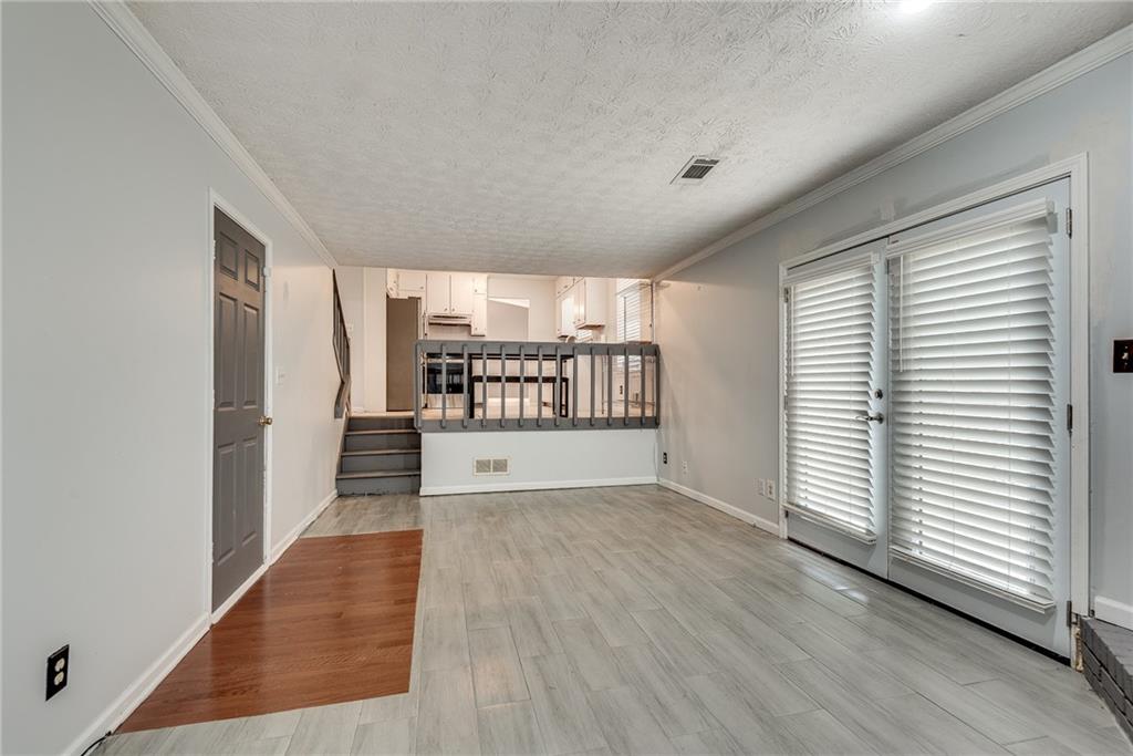 5611 Whittondale Road Lithonia, GA 30058 - Photo 13 of 34 wooden floor in an empty room with a window