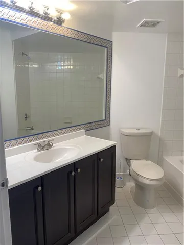 a bathroom with a sink toilet and mirror