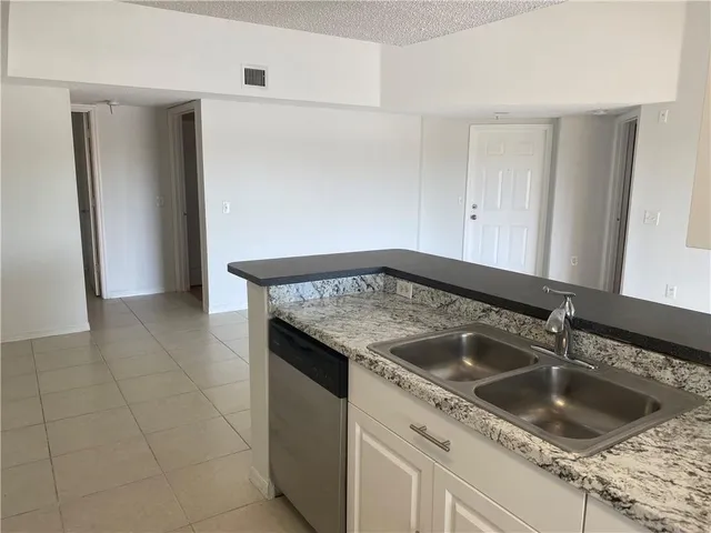 a kitchen with a sink and cabinets