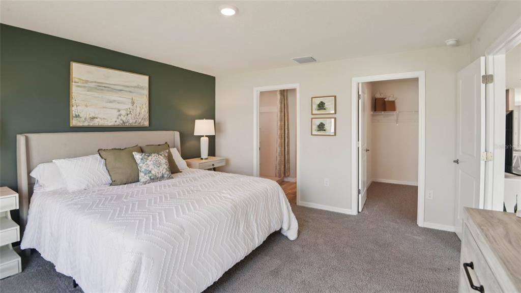 3052 Northeast 21st Ct Road Ocala, FL 34479 - Photo 12 of 21 a bedroom with a bed and painting on the wall