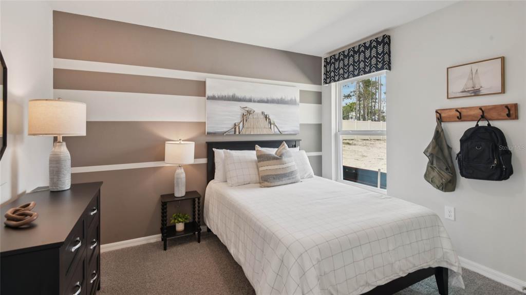 3052 Northeast 21st Ct Road Ocala, FL 34479 - Photo 16 of 21 a bedroom with a bed and lamp