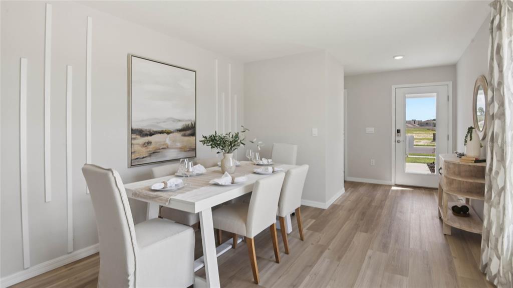 3052 Northeast 21st Ct Road Ocala, FL 34479 - Photo 2 of 21 a view of a dining room with furniture and wooden floor