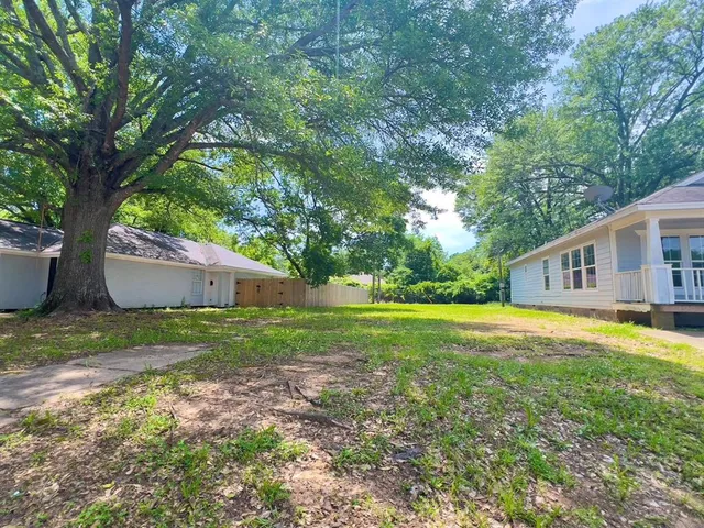a view of a house with yard and a garden