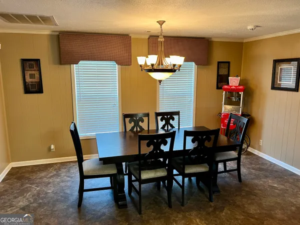 a view of a dining room with furniture and chandelier