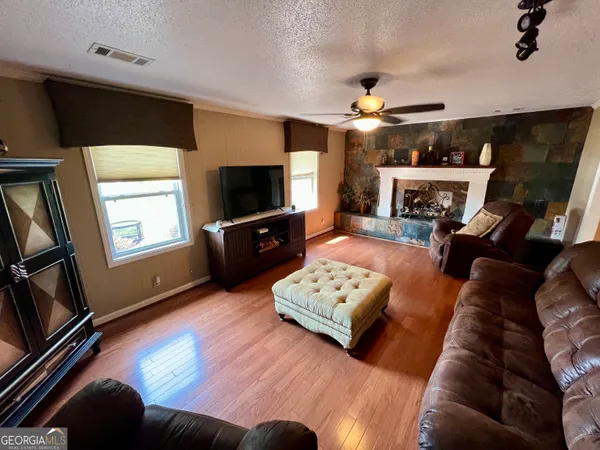a bedroom with a bed dresser and a window