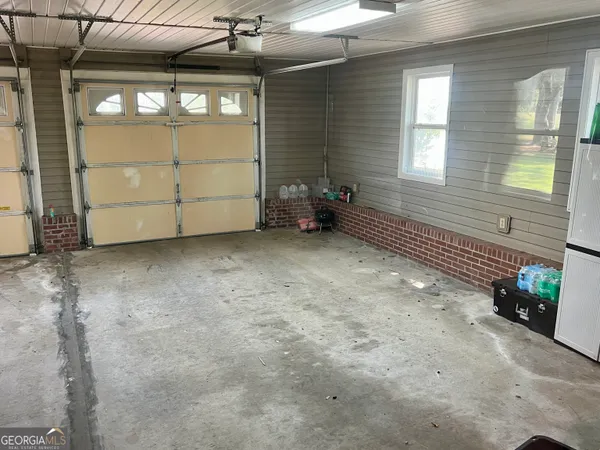 a view of a hallway with wooden floor and entryway