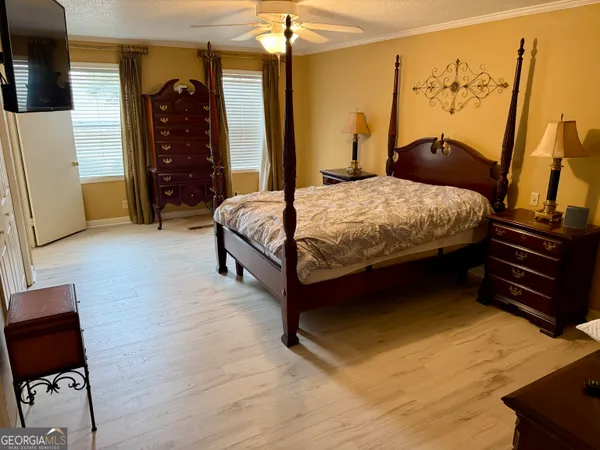 a bed sitting in a bedroom next to a window