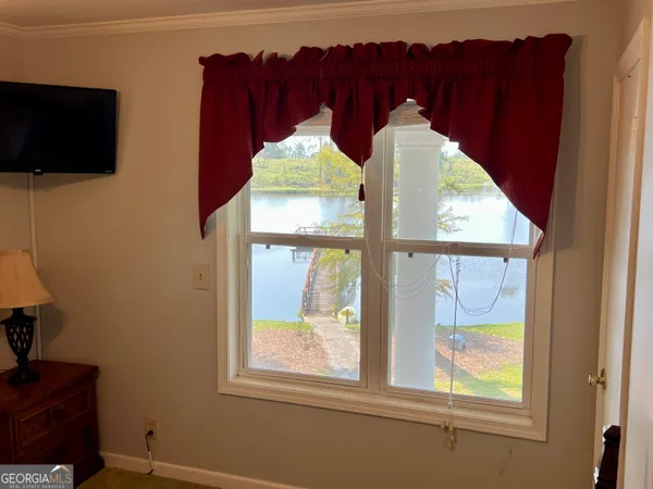 a view of a two room with wooden floor and outdoor seating