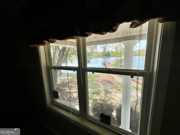 a view of a house with pool and a yard