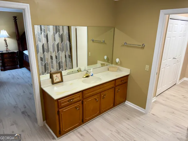 a kitchen with stainless steel appliances granite countertop a refrigerator a sink a stove and white cabinets