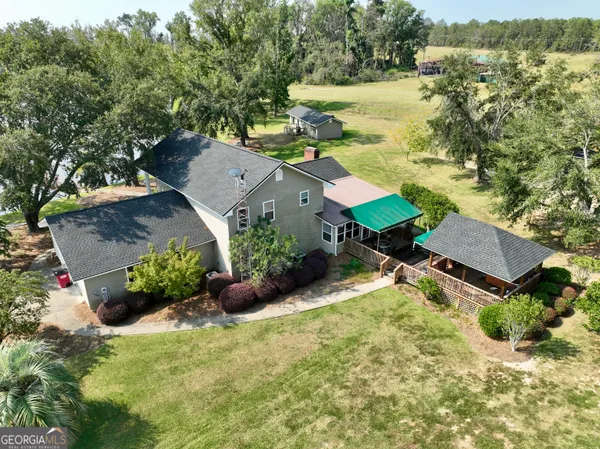 a view of a hallway with wooden floor and stairs