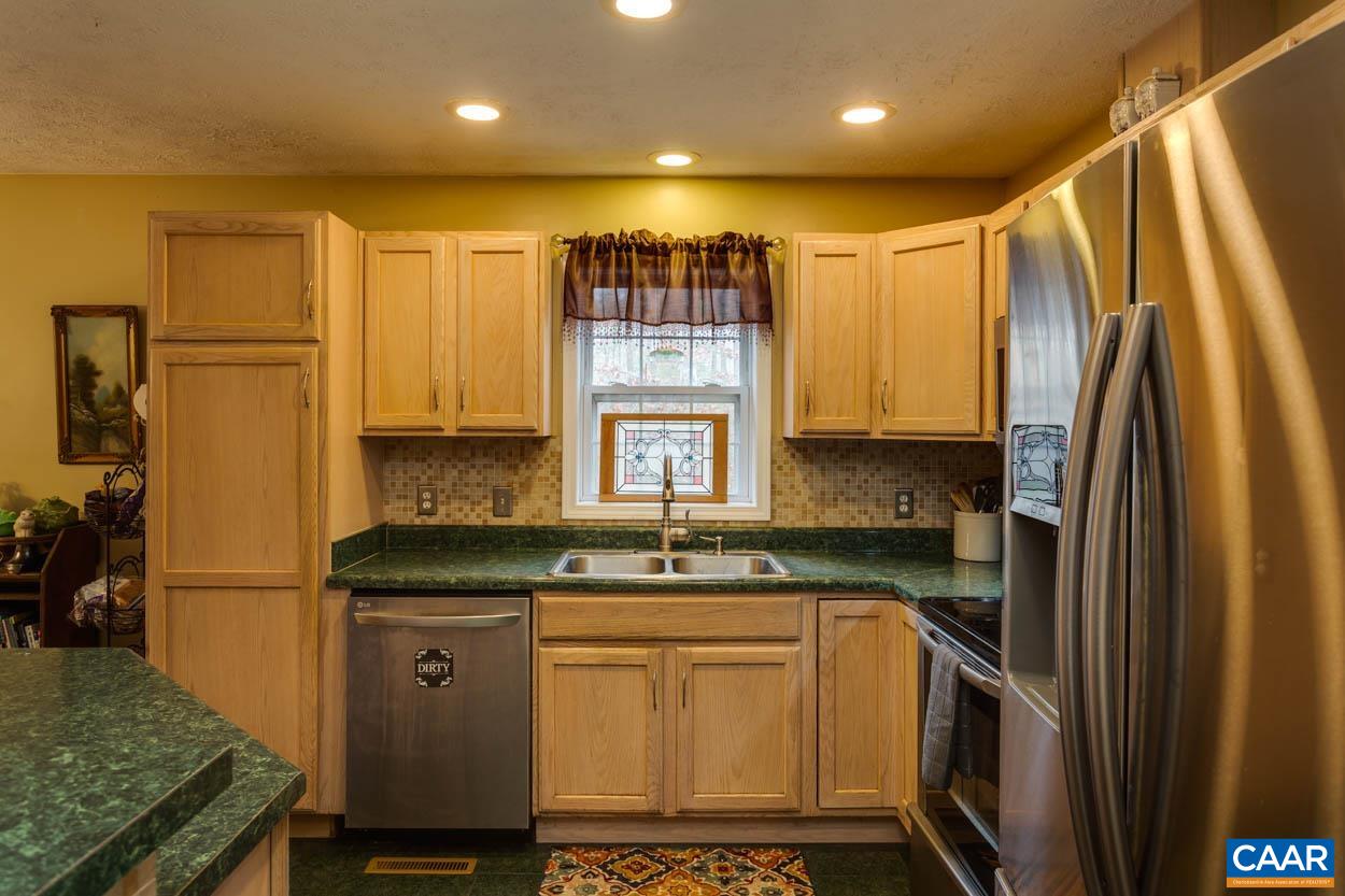 39 Paynes Mill Road Troy, VA 22974 - Photo 16 of 54 a kitchen with a sink a refrigerator and cabinets