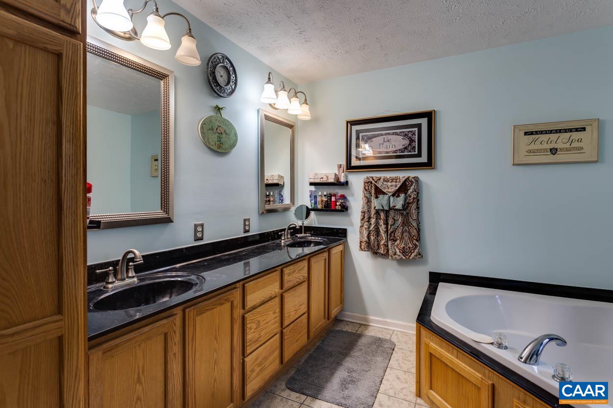39 Paynes Mill Road Troy, VA 22974 - Photo 24 of 54 a kitchen with stainless steel appliances granite countertop a sink and a stove with wooden floor