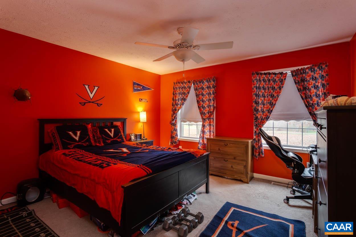 39 Paynes Mill Road Troy, VA 22974 - Photo 30 of 54 a bedroom with a bed and a chandelier