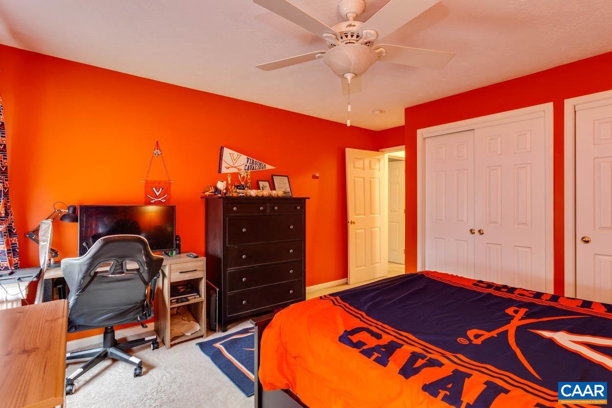 39 Paynes Mill Road Troy, VA 22974 - Photo 31 of 54 a bedroom with a bed and a chandelier