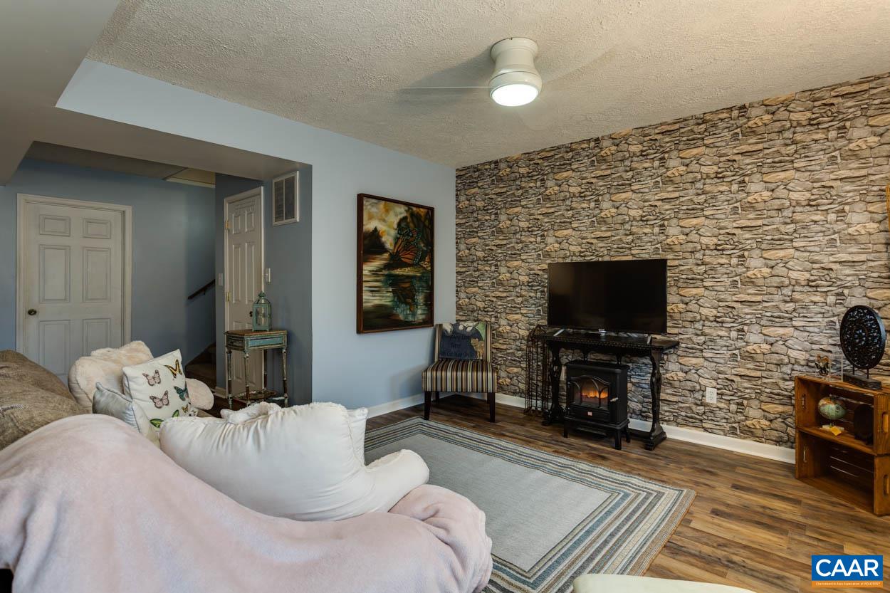 39 Paynes Mill Road Troy, VA 22974 - Photo 37 of 54 a living room with furniture a flat screen tv and a fireplace