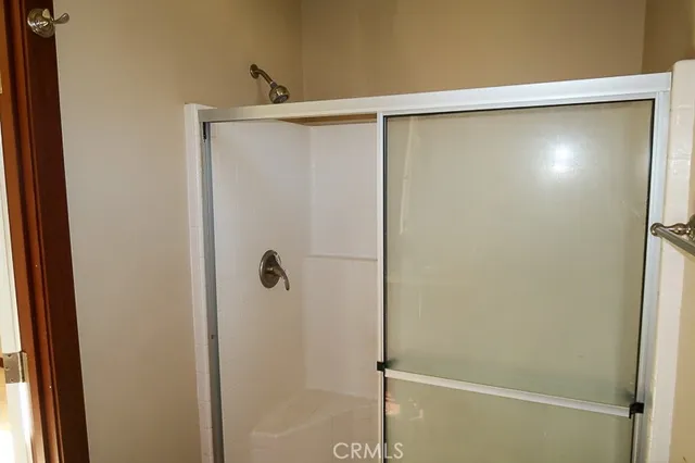 a bathroom with a glass shower door
