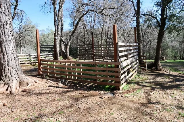 a view of street with wooden fence
