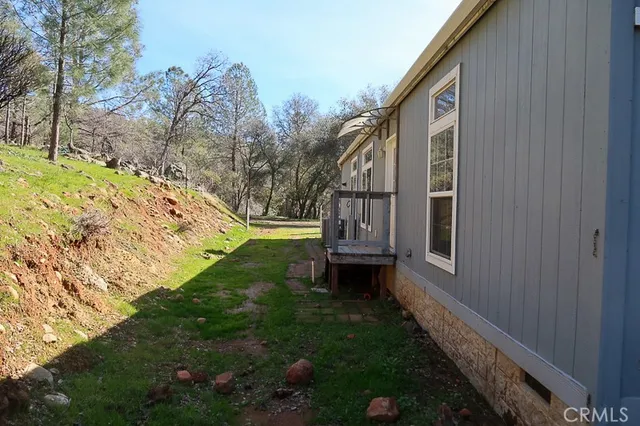 a view of house with backyard and garden
