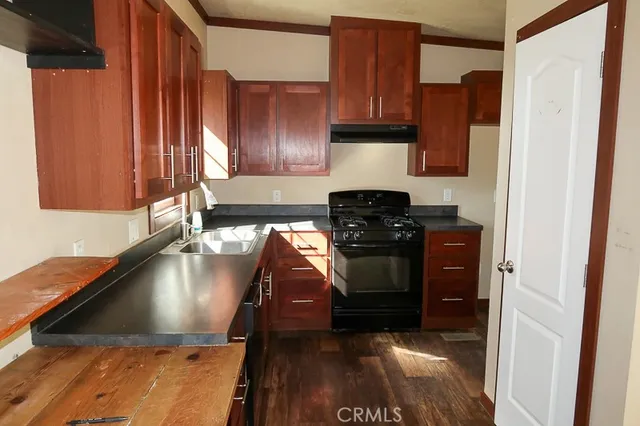a kitchen with a sink and a stove top oven
